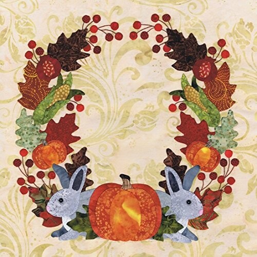 Autumn wreath with pumpkins, berries, leaves, and rabbits.