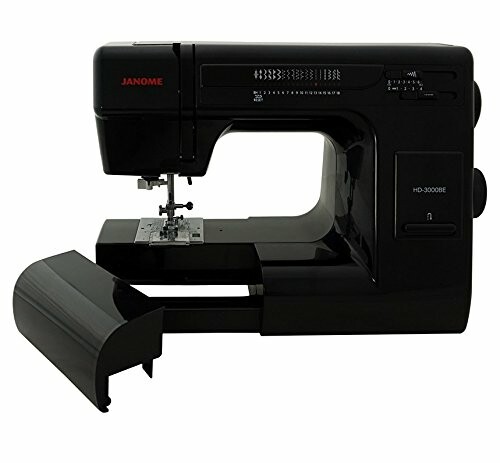 Black sewing machine with open accessory compartment.