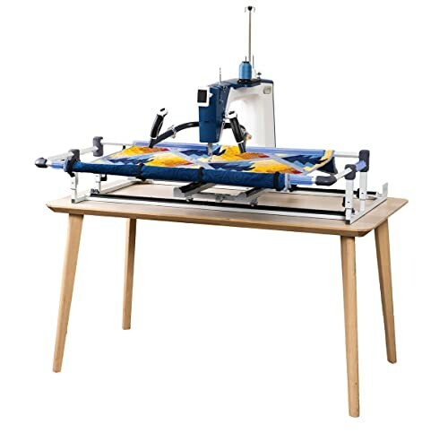 Quilting machine on a wooden table with colorful fabric.